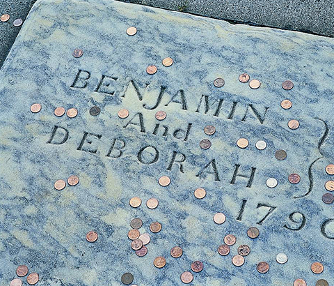 Pennies tossed on Ben Franklin's tombstone